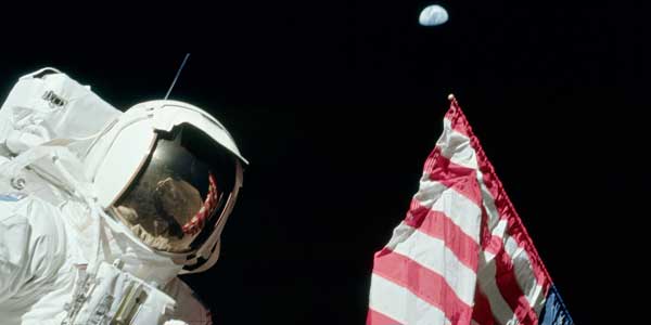 Scientist-Astronaut Harrison Schmitt, Apollo 17 lunar module pilot, next to the U.S. flag at the Taurus-Littrow landing site.