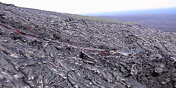 Kilauea aa flows in 2002 showing channel with flow below the levees